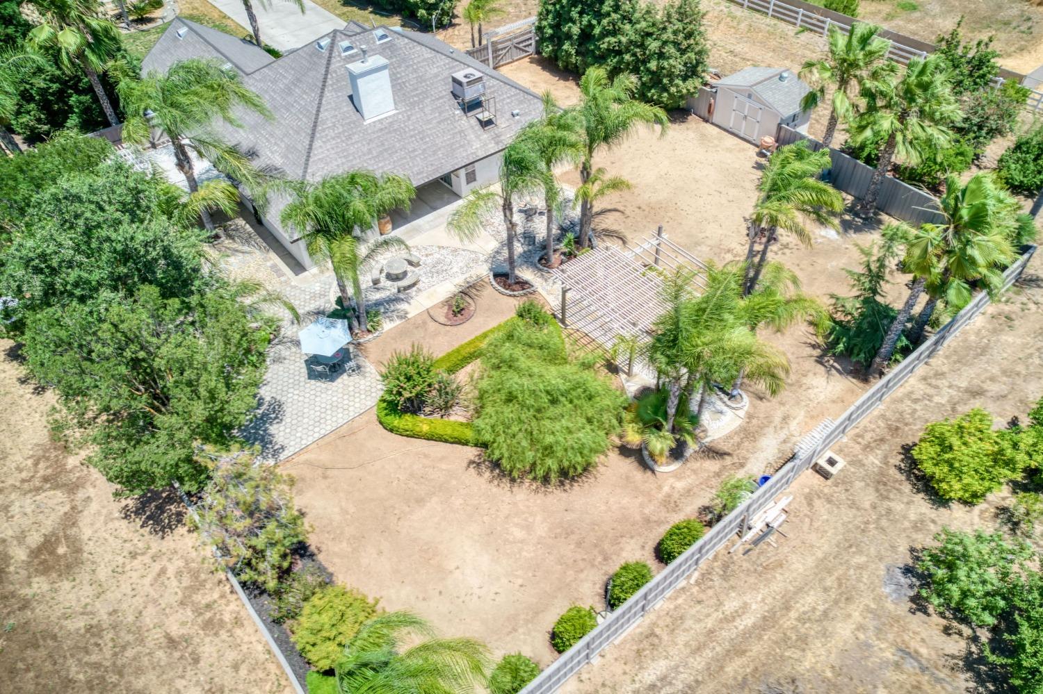 25106 Ave 18 Madera, CA 93638 - Photo 55 of 66 an aerial view of a house with a yard and a lot of flower plants