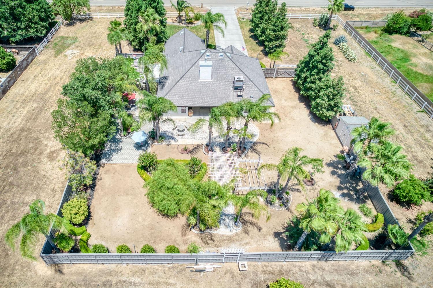 25106 Ave 18 Madera, CA 93638 - Photo 56 of 66 an aerial view of a house with a yard and a large pool