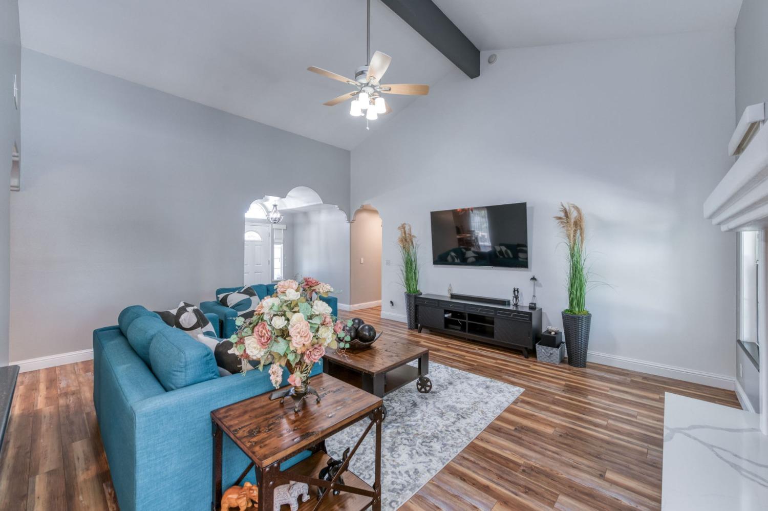 25106 Ave 18 Madera, CA 93638 - Photo 6 of 66 a living room with furniture fireplace and flat screen tv