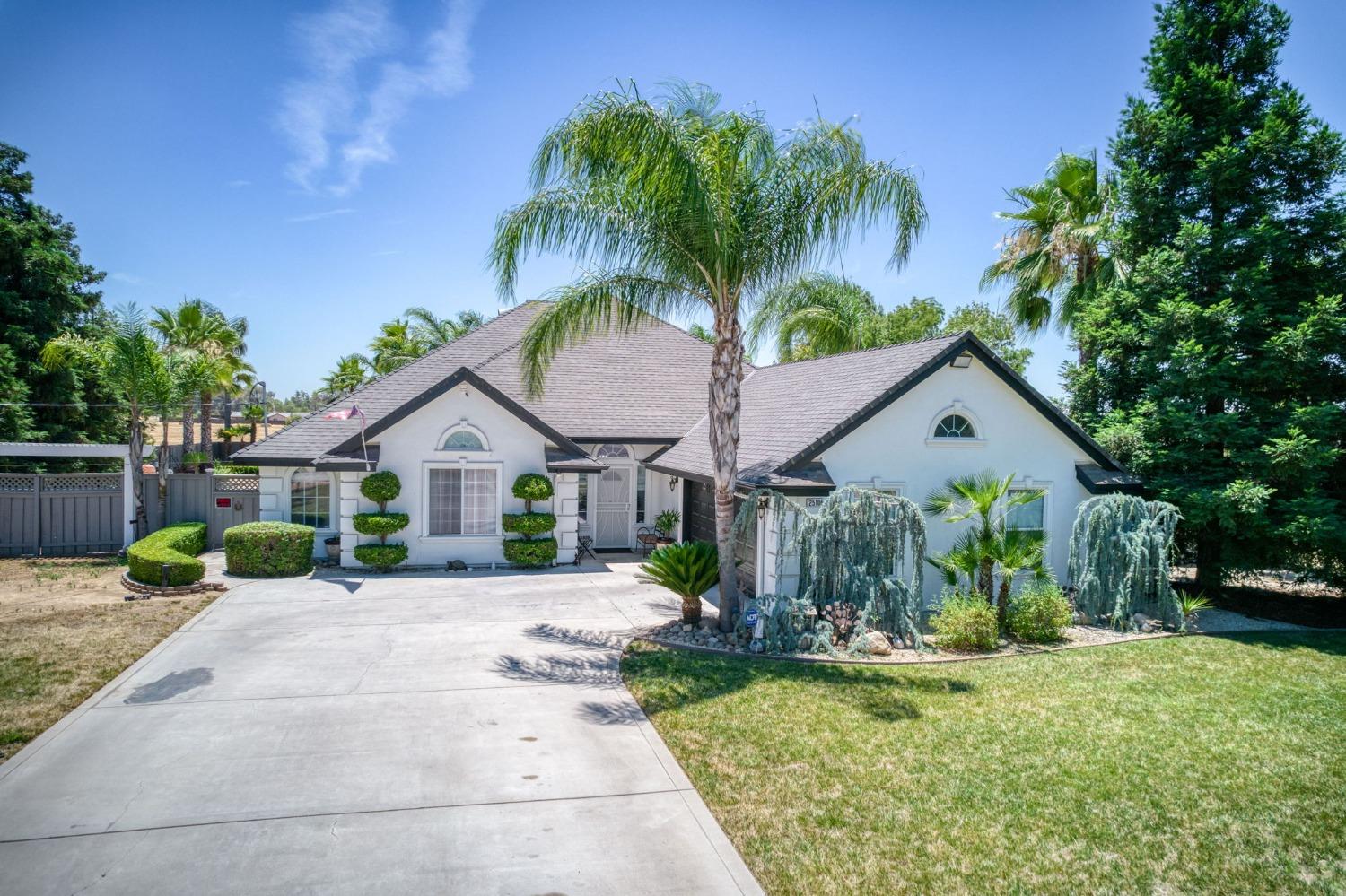 25106 Ave 18 Madera, CA 93638 - Photo 66 of 66 a view of a house with backyard and a tree
