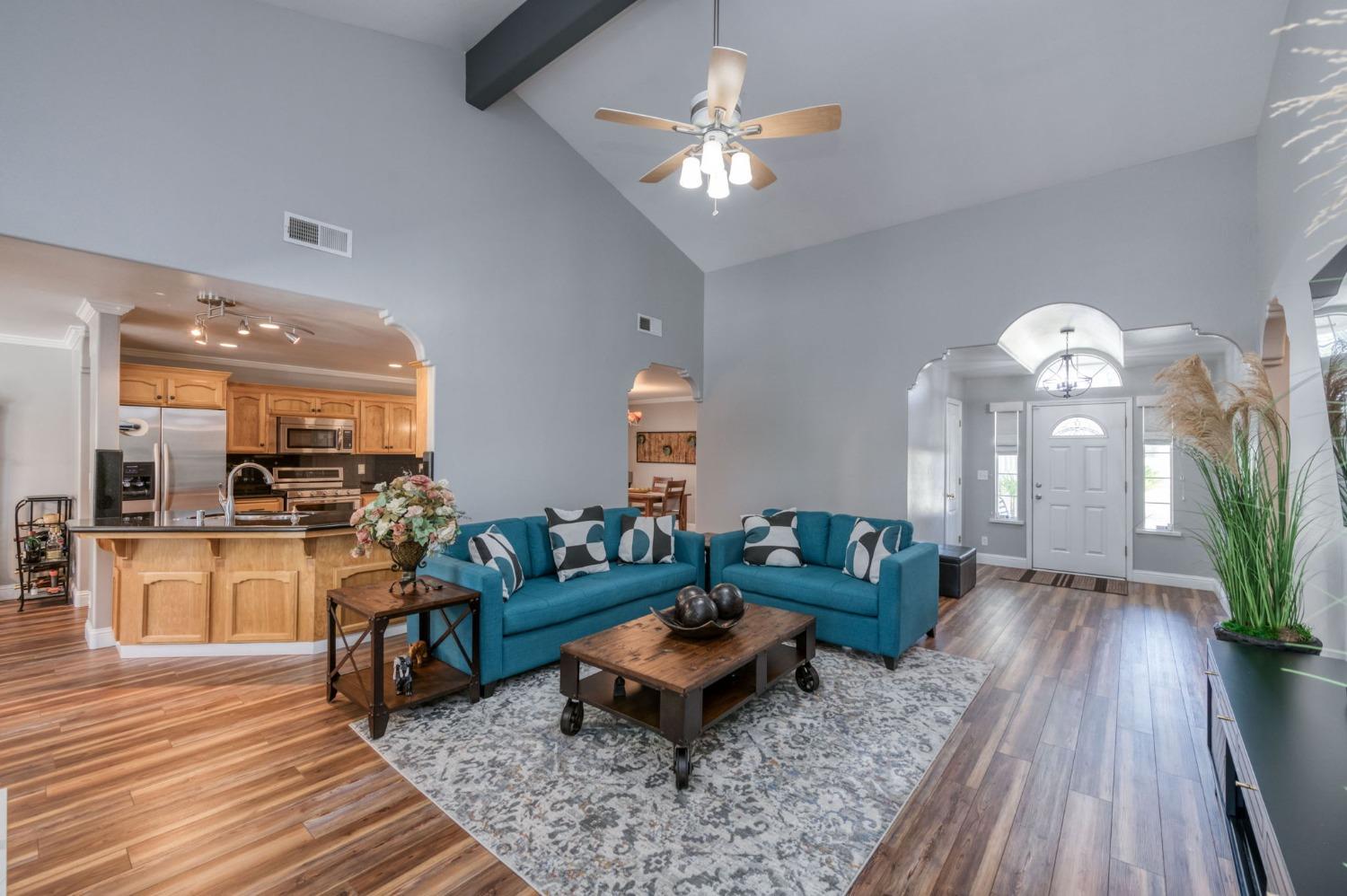 25106 Ave 18 Madera, CA 93638 - Photo 7 of 66 a living room with furniture a chandelier and a rug