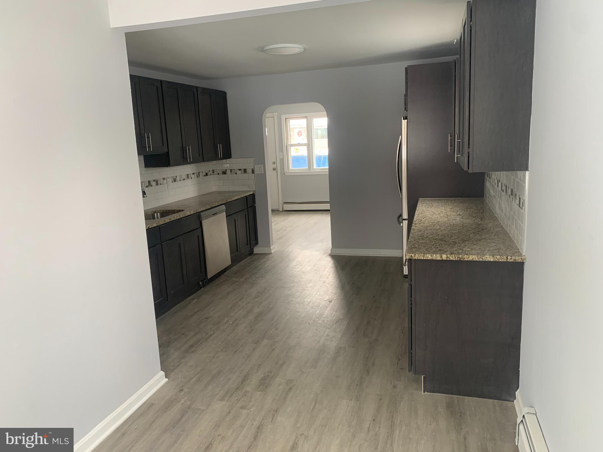 a view of a kitchen cabinets a sink and a microwave