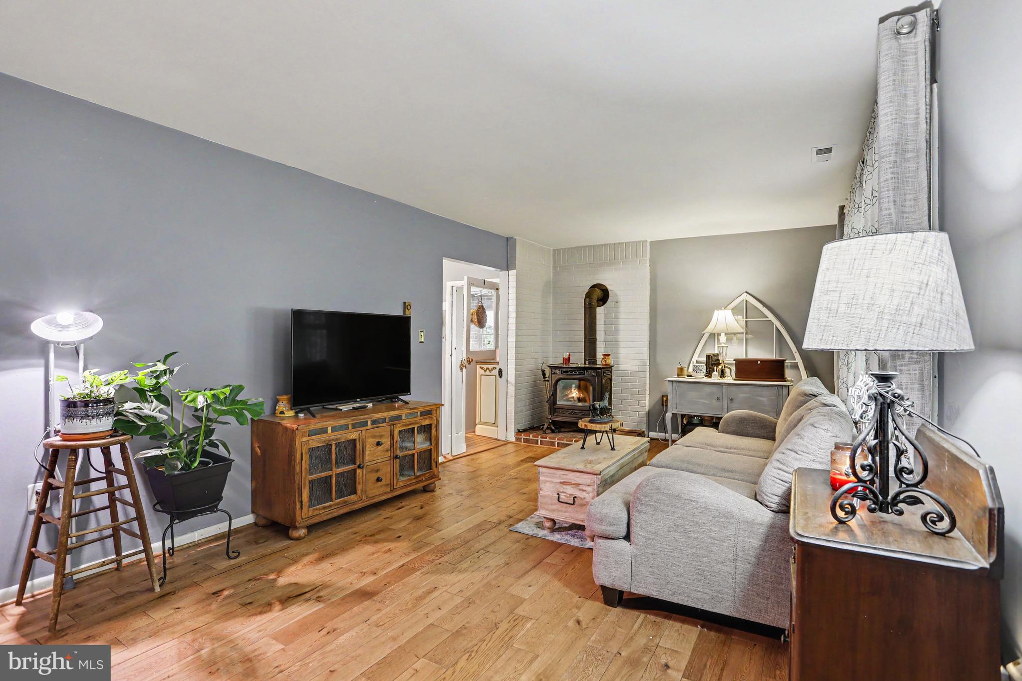 2226 Harney Road Littlestown, PA 17340 - Photo 12 of 40 a living room with furniture and a flat screen tv