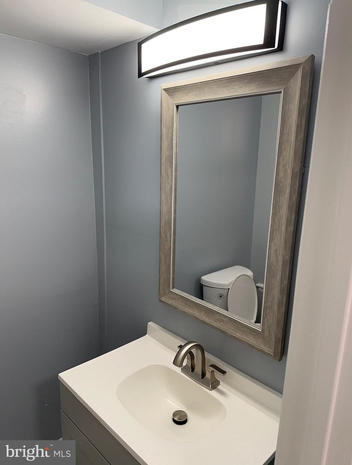 1002 North Pine Street Wilmington, DE 19801 - Photo 15 of 29 a bathroom with a sink and mirror