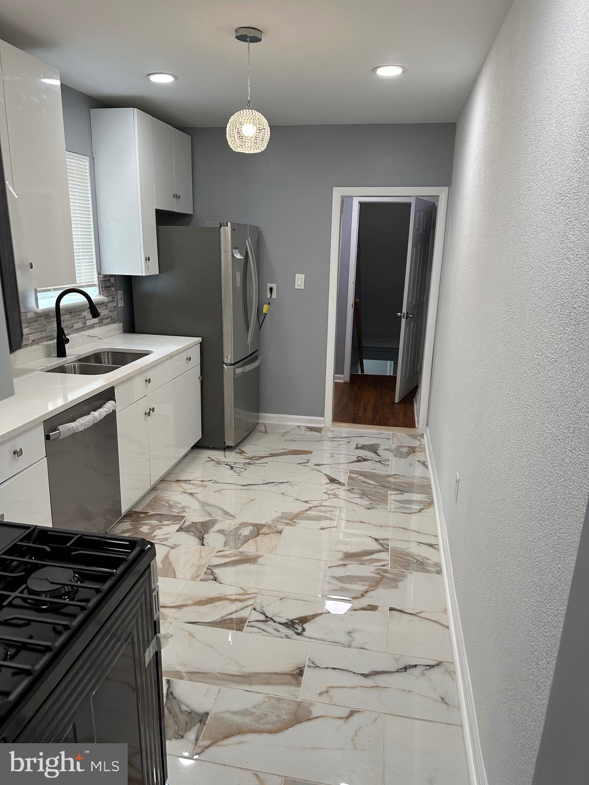 1002 North Pine Street Wilmington, DE 19801 - Photo 25 of 29 a kitchen with a sink and refrigerator