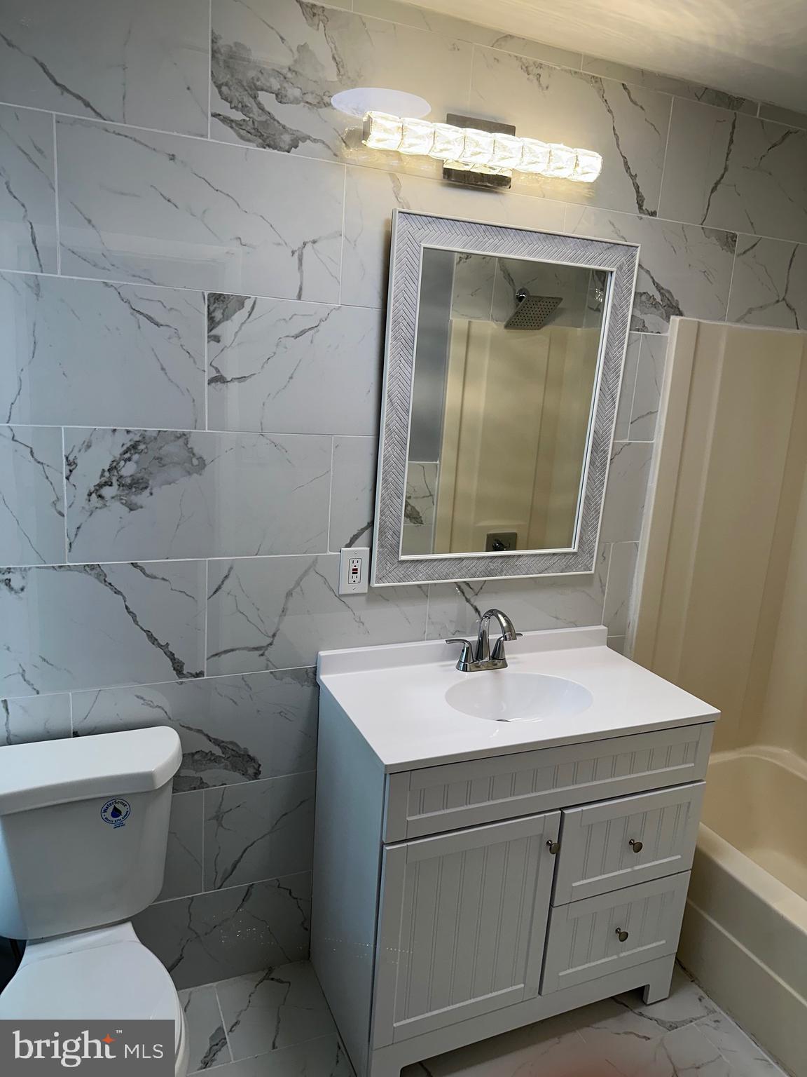 1002 North Pine Street Wilmington, DE 19801 - Photo 28 of 29 a bathroom with a sink toilet and mirror