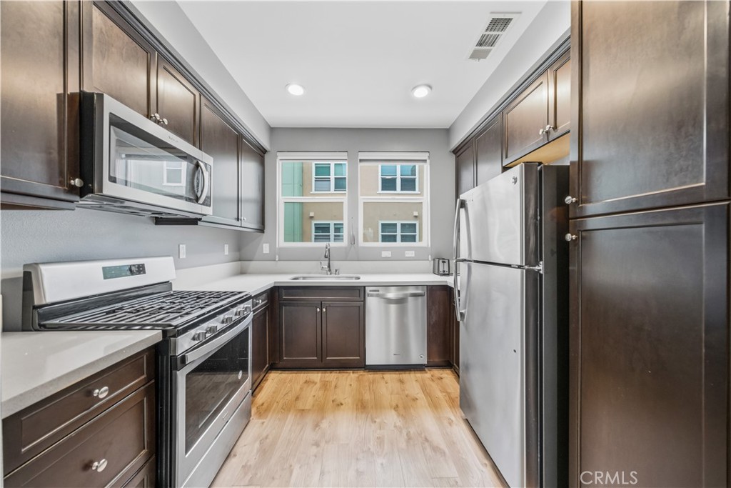 8847 Jacaranda Avenue, Unit C Montclair, CA 91763 - Photo 13 of 34 a kitchen with stainless steel appliances granite countertop a refrigerator stove and sink