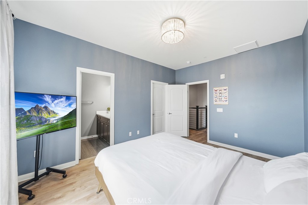 8847 Jacaranda Avenue, Unit C Montclair, CA 91763 - Photo 24 of 34 a bedroom with a bed and a flat screen tv