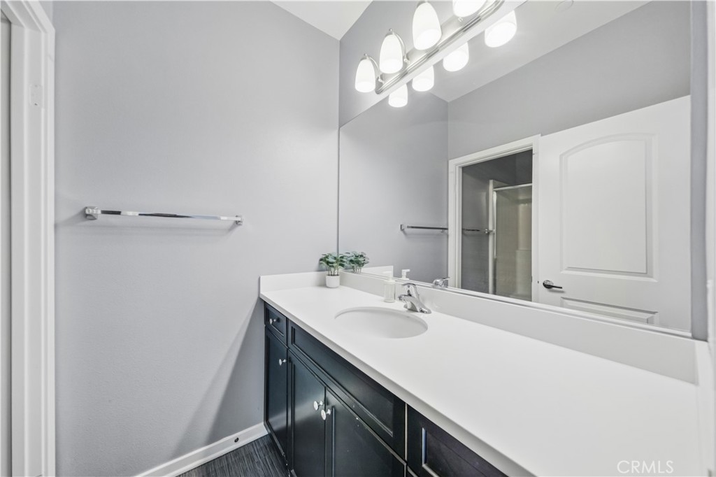 8847 Jacaranda Avenue, Unit C Montclair, CA 91763 - Photo 25 of 34 a bathroom with a sink a vanity and a mirror