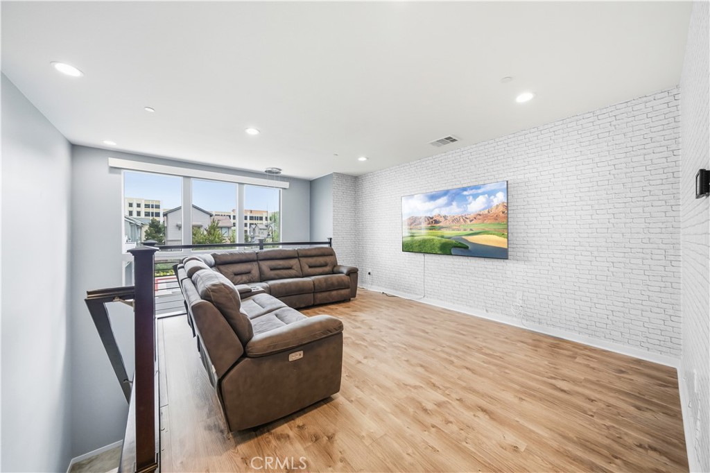 8847 Jacaranda Avenue, Unit C Montclair, CA 91763 - Photo 6 of 34 a living room with furniture and a wooden floor