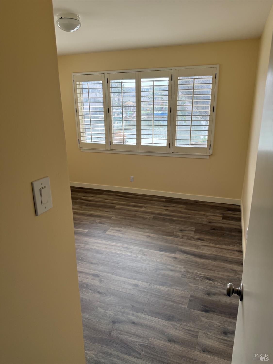 16 Harbor View Court San Rafael, CA 94901 - Photo 16 of 20 a view of an empty room with wooden floor and a window