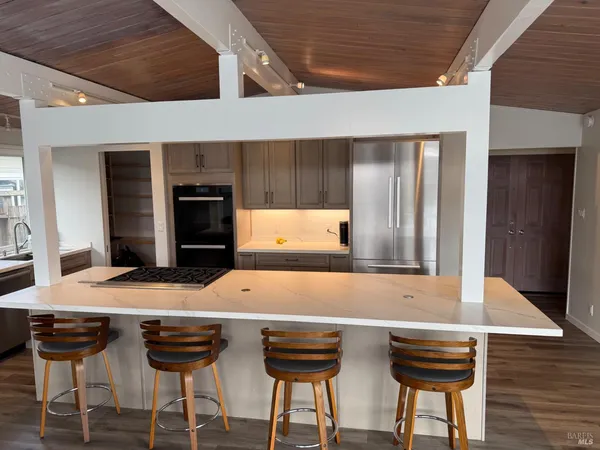 a kitchen with sink a stove and cabinets