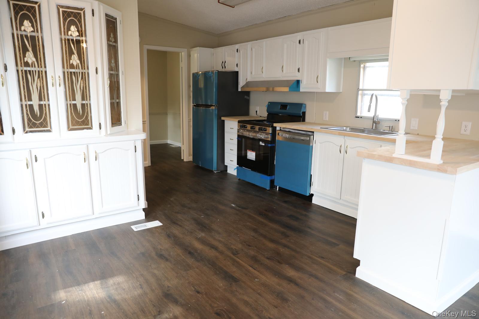 179 Van Wagner Road, Unit LOT 42 Poughkeepsie, NY 12603 - Photo 11 of 19 a kitchen with stainless steel appliances a refrigerator and a stove top oven