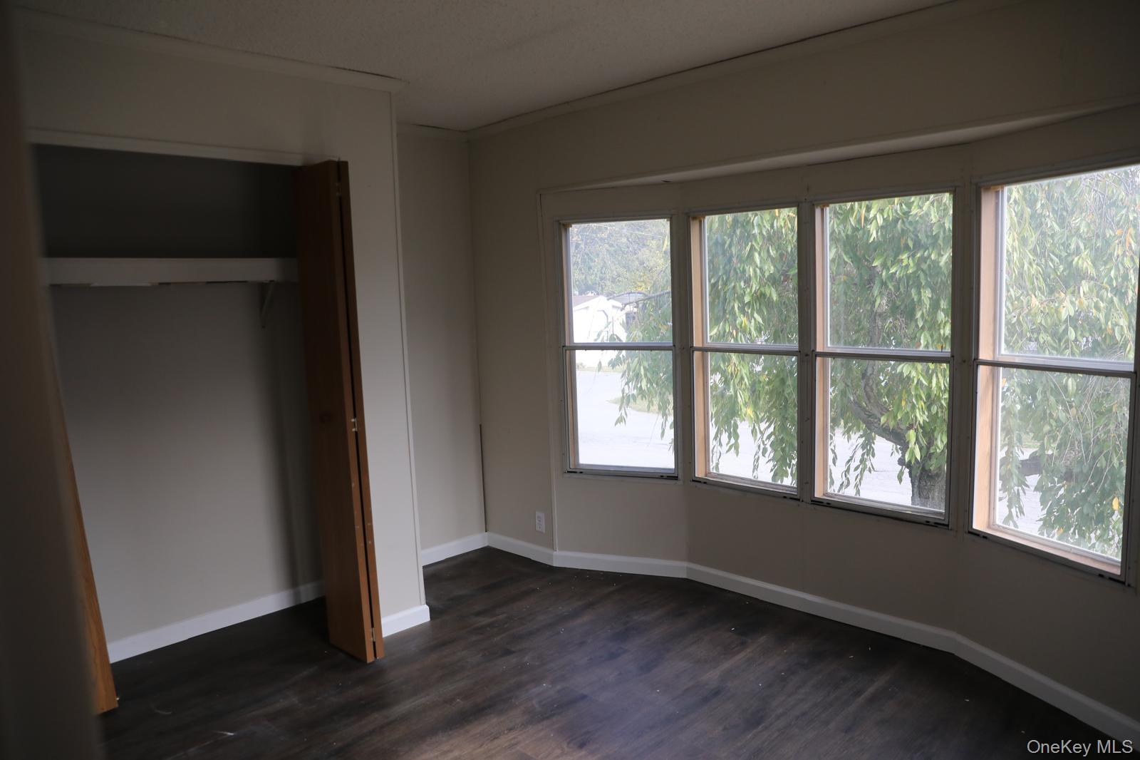 179 Van Wagner Road, Unit LOT 42 Poughkeepsie, NY 12603 - Photo 13 of 19 a view of an empty room with wooden floor and a window