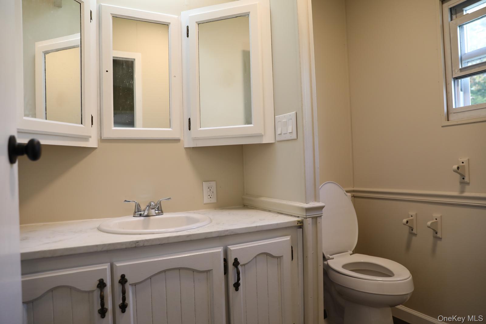 179 Van Wagner Road, Unit LOT 42 Poughkeepsie, NY 12603 - Photo 15 of 19 a bathroom with a sink a toilet and a mirror