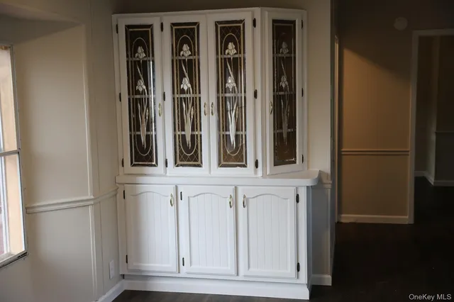 a view of kitchen with wooden floor electronic appliances and window