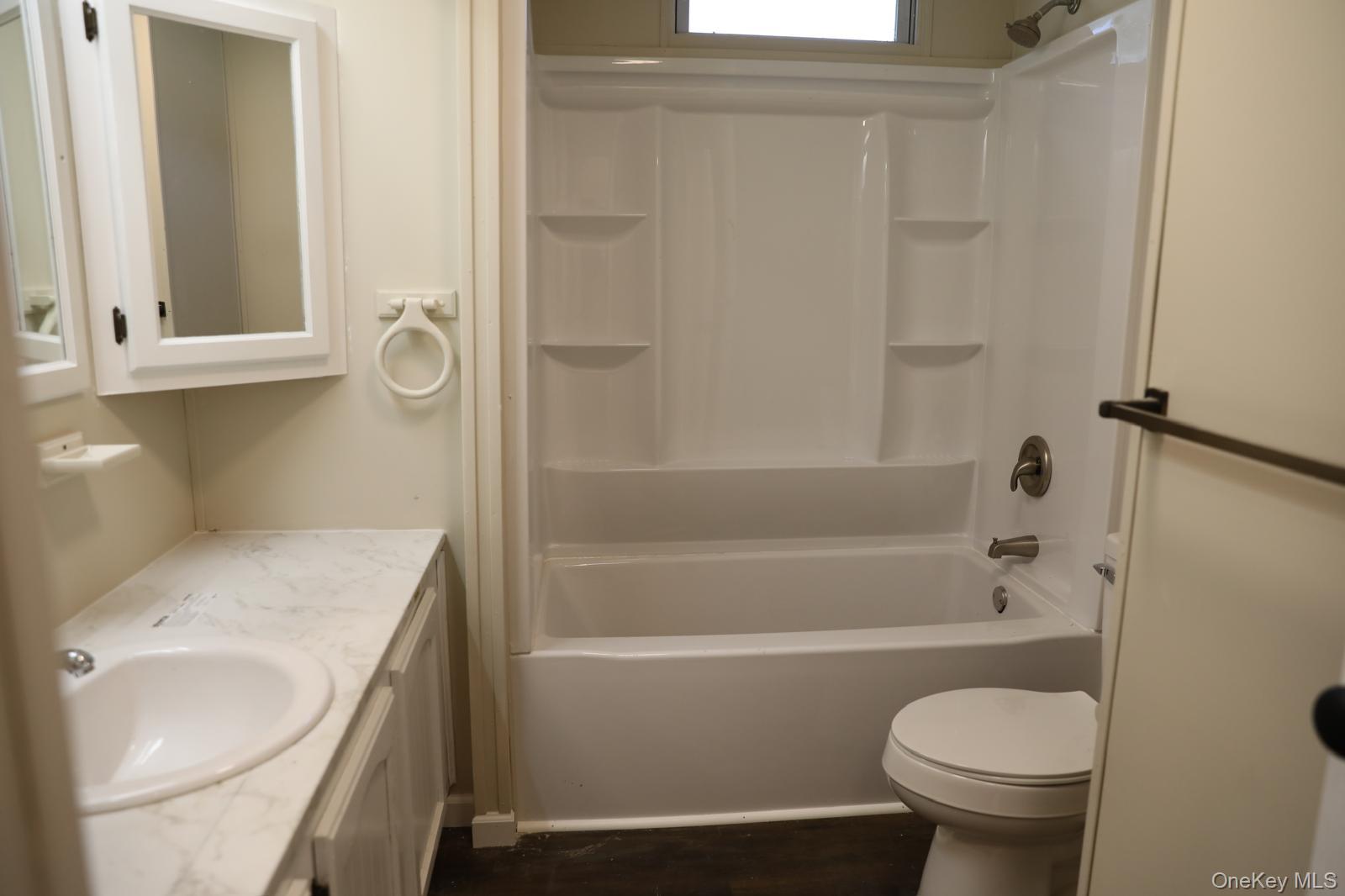 179 Van Wagner Road, Unit LOT 42 Poughkeepsie, NY 12603 - Photo 18 of 19 a bathroom with a sink a toilet and shower