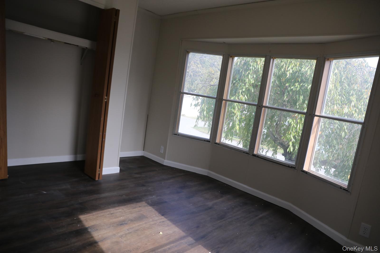 179 Van Wagner Road, Unit LOT 42 Poughkeepsie, NY 12603 - Photo 19 of 19 an empty room with wooden floor and windows