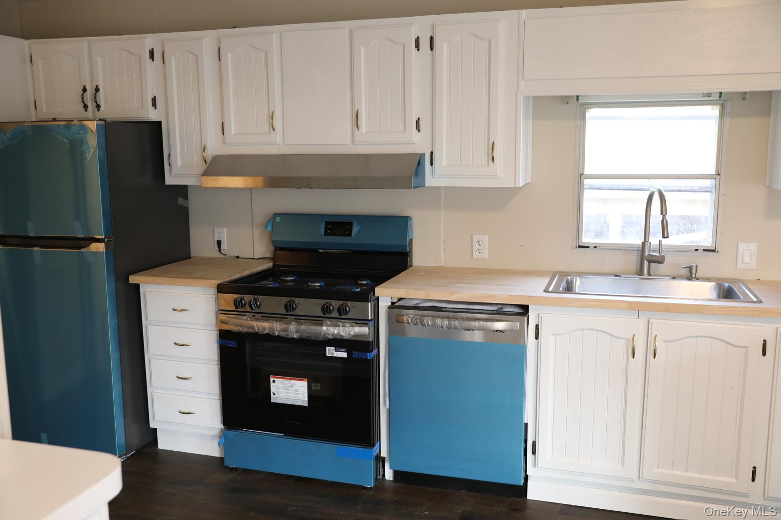 179 Van Wagner Road, Unit LOT 42 Poughkeepsie, NY 12603 - Photo 7 of 19 a kitchen with granite countertop white cabinets and white appliances