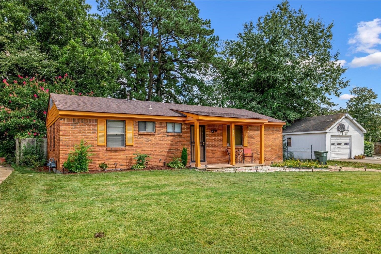 3128 Cherry Road Memphis, TN 38118 - Photo 3 of 40 a front view of a house with a yard and trees