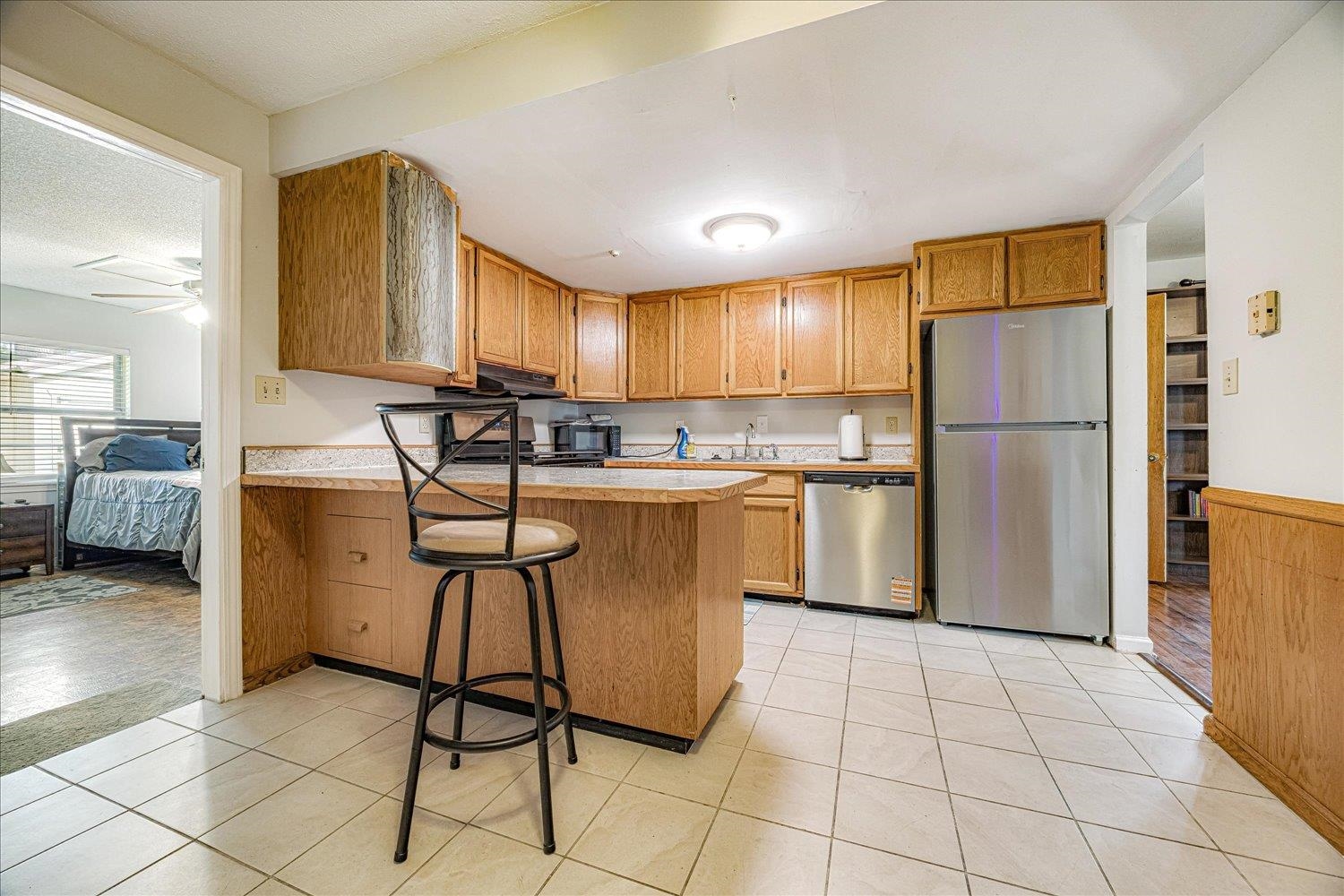 3128 Cherry Road Memphis, TN 38118 - Photo 10 of 40 a kitchen with a refrigerator a counter top space and cabinets