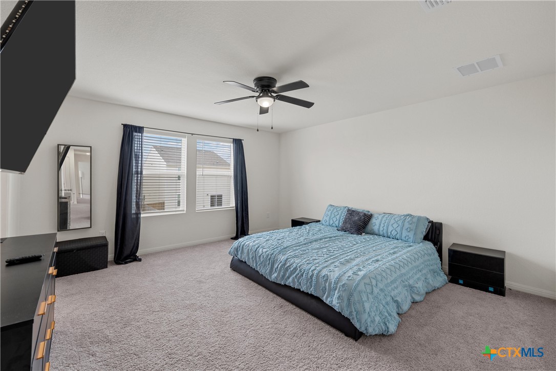 121 Sudden Impact Drive Jarrell, TX 76537 - Photo 13 of 38 a bedroom with a bed dresser and a window