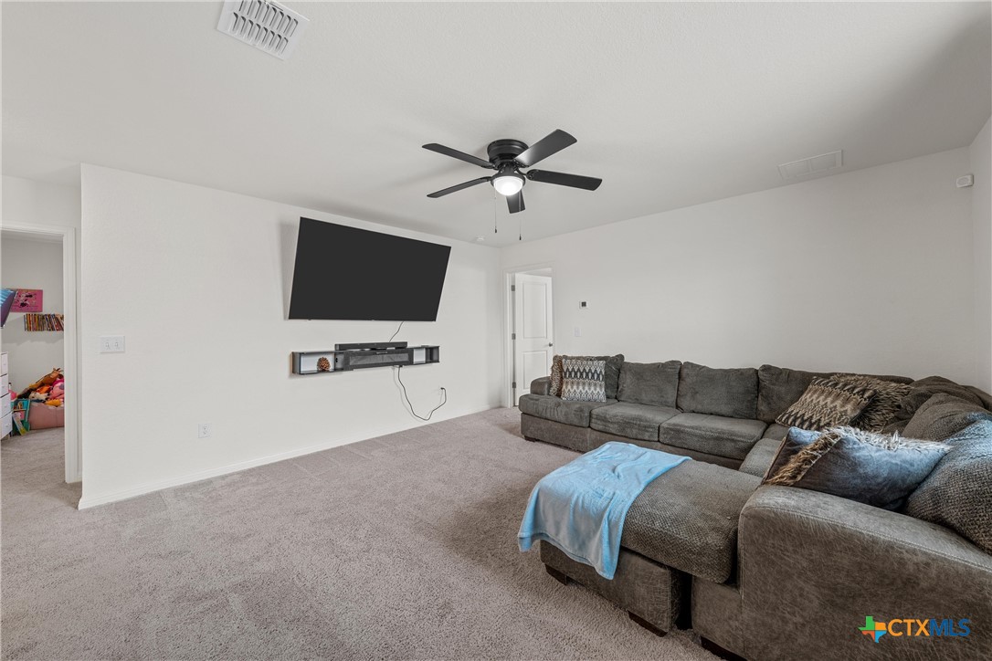 121 Sudden Impact Drive Jarrell, TX 76537 - Photo 18 of 38 a living room with furniture and a flat screen tv