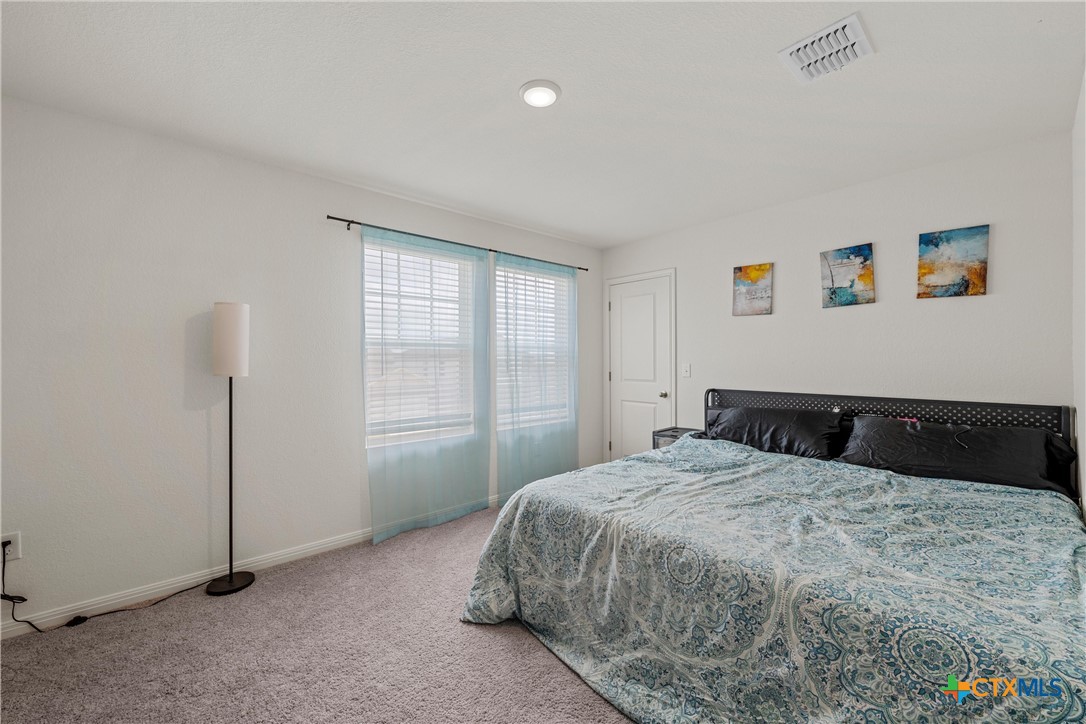 121 Sudden Impact Drive Jarrell, TX 76537 - Photo 21 of 38 a bedroom with a bed and a window