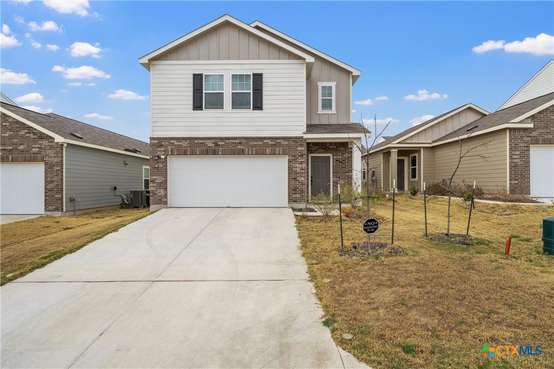 121 Sudden Impact Drive Jarrell, TX 76537 - Photo 3 of 38 a front view of a house with garden