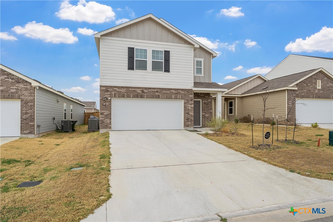 121 Sudden Impact Drive Jarrell, TX 76537 - Photo 4 of 38 a front view of a house with a yard and garage
