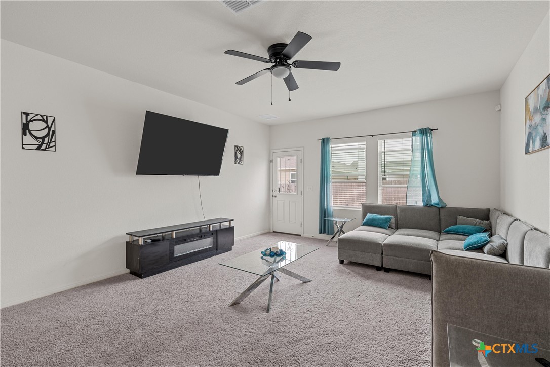 121 Sudden Impact Drive Jarrell, TX 76537 - Photo 6 of 38 a living room with furniture and a flat screen tv