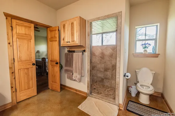 a kitchen with stainless steel appliances a table and chairs