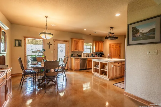 a living room with lots of furniture and kitchen view