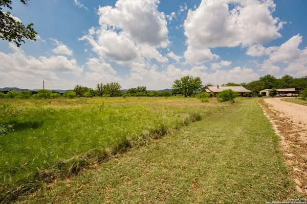 a view of a lake with a yard