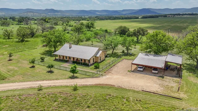 a living room with furniture a fireplace and a chandelier