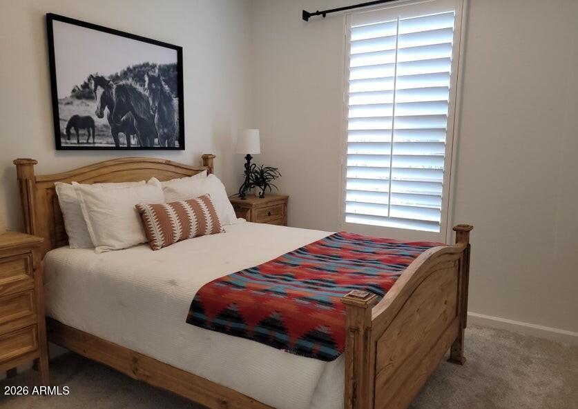 4540 Jackpot Road Wickenburg, AZ 85390 - Photo 8 of 13 a bedroom with a bed and a painting on the wall