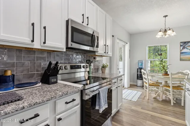 a kitchen with counter top space cabinets and appliances