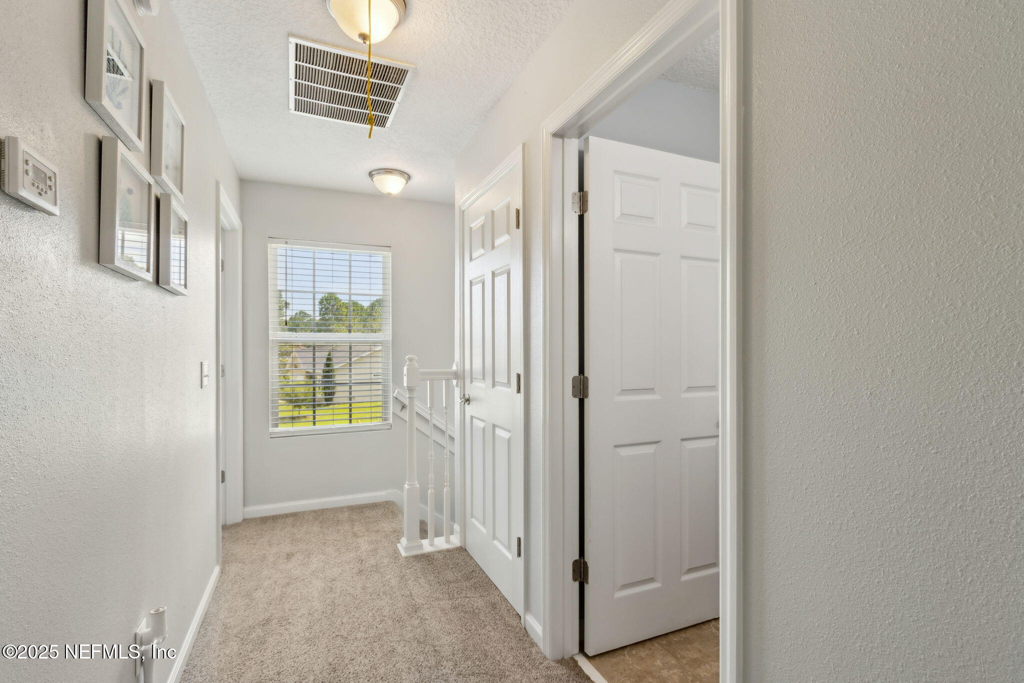 95152 Cypress Trail Fernandina Beach, FL 32034 - Photo 18 of 29 a view of an empty room with a window and wooden floor