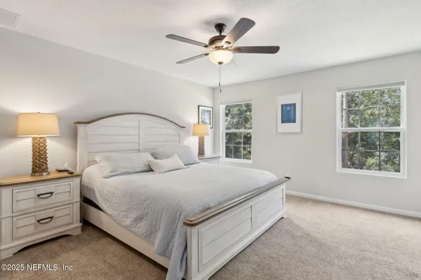 a bedroom with a bed and ceiling fan