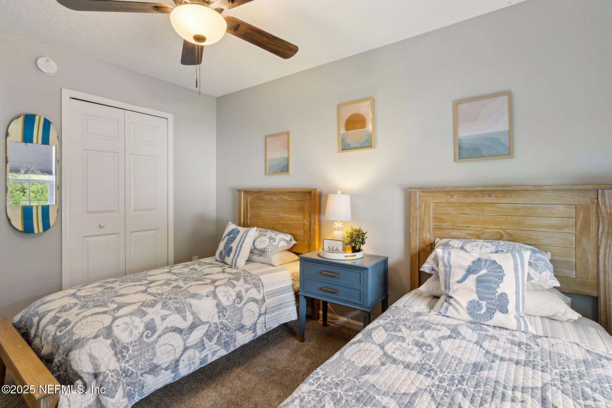 95152 Cypress Trail Fernandina Beach, FL 32034 - Photo 25 of 29 a bedroom with a bed and a chandelier