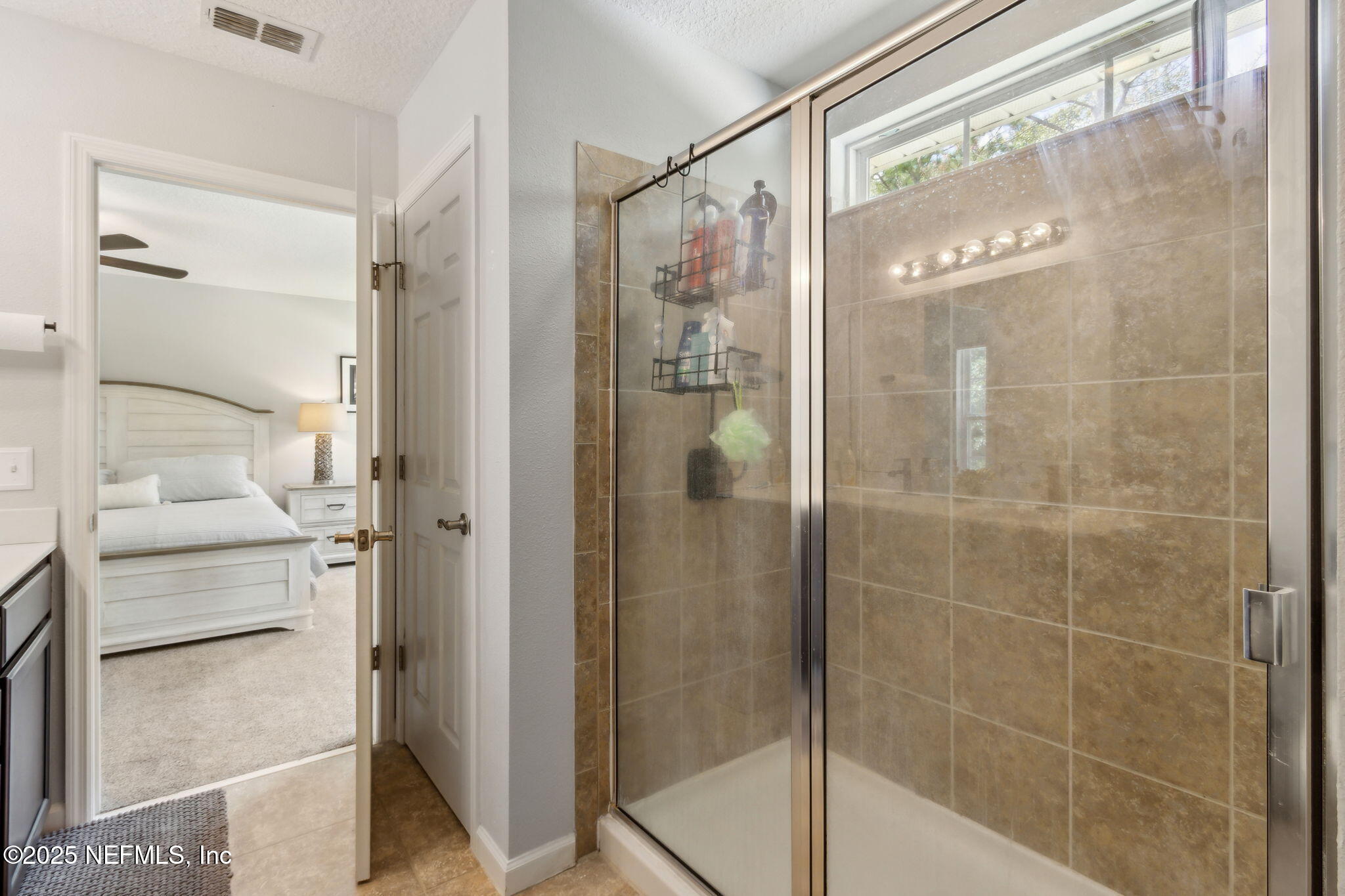95152 Cypress Trail Fernandina Beach, FL 32034 - Photo 26 of 29 a bathroom with a glass shower door and a mirror