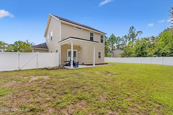 a view of a backyard with plants and a patio