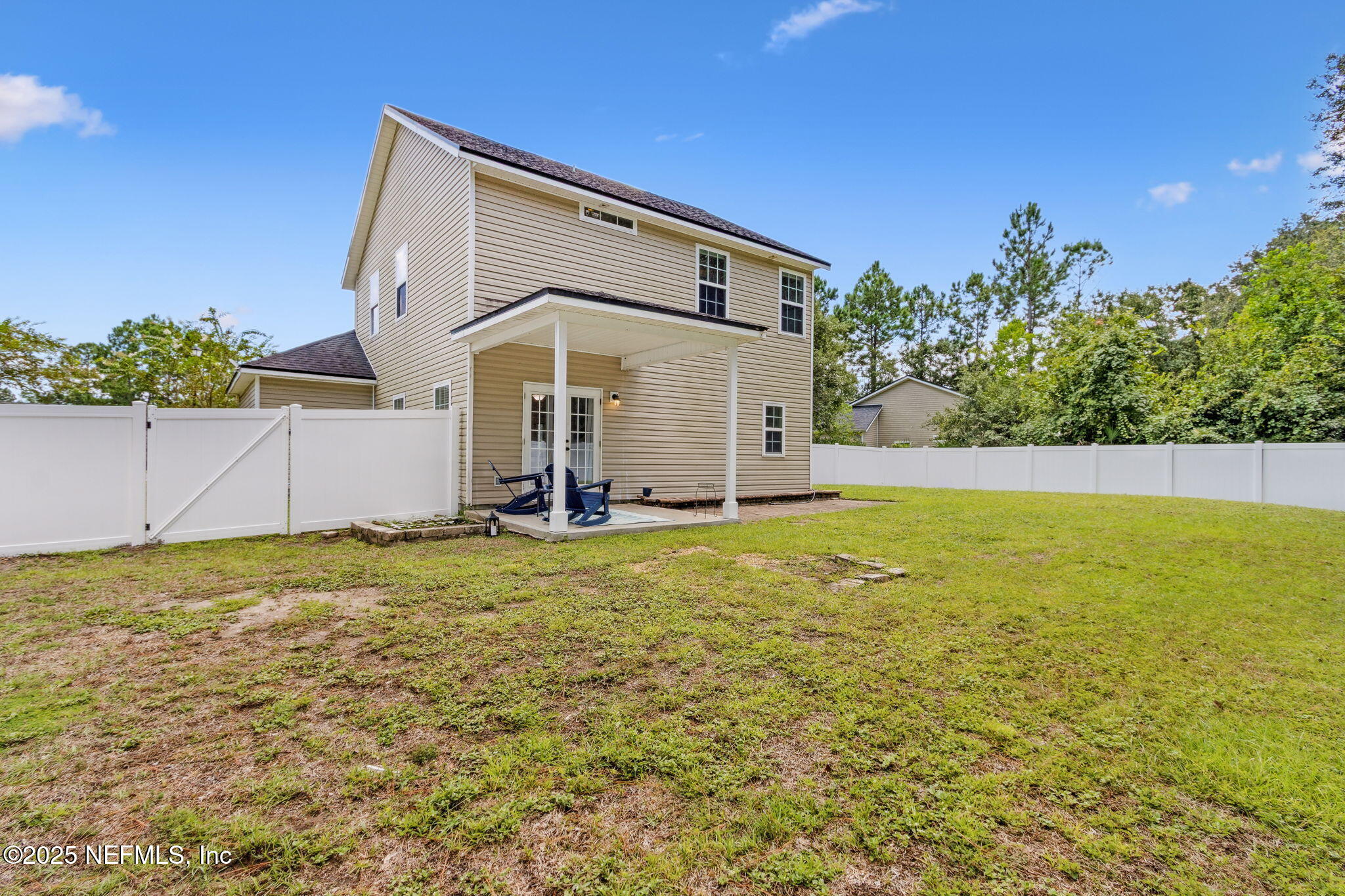 95152 Cypress Trail Fernandina Beach, FL 32034 - Photo 27 of 29 a front view of house with yard and trees in the background
