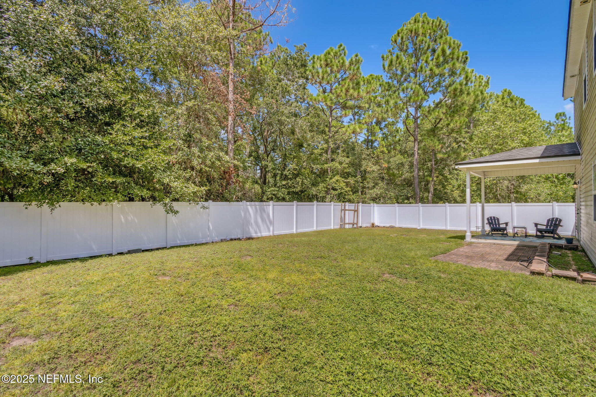 95152 Cypress Trail Fernandina Beach, FL 32034 - Photo 28 of 29 a view of a backyard with plants and a patio