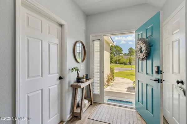 a view of entryway with wooden floor and stairs