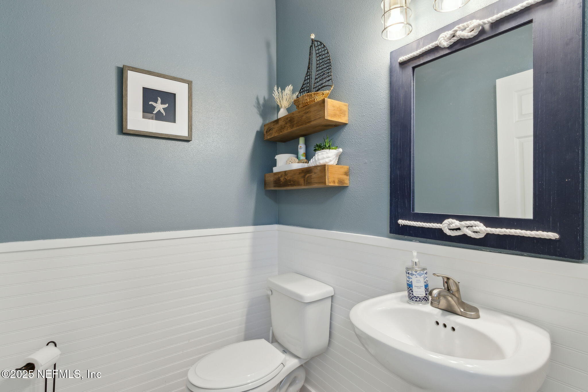 95152 Cypress Trail Fernandina Beach, FL 32034 - Photo 7 of 29 a bathroom with a toilet sink and mirror