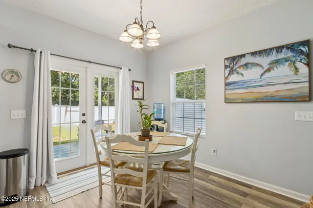 a kitchen with sink refrigerator dining table and chairs