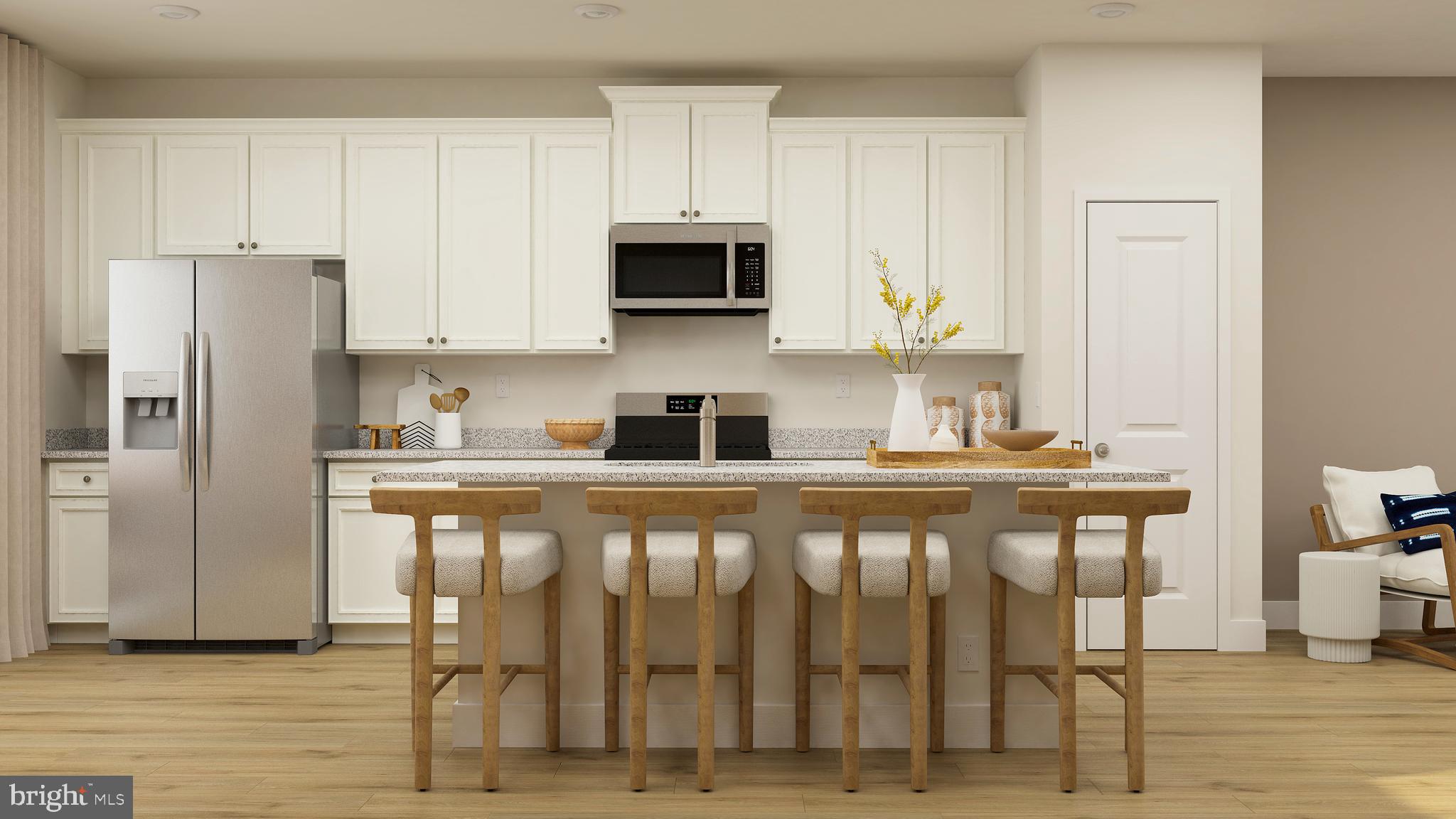 7612 Johnnycake Road Windsor Mill, MD 21244 - Photo 2 of 11 a kitchen with stainless steel appliances granite countertop a stove top oven a refrigerator and white cabinets