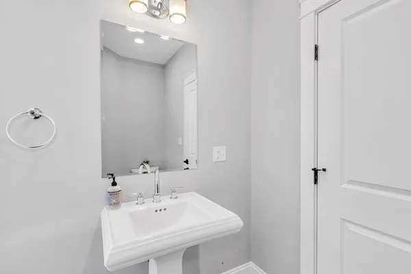 a bathroom with a sink a mirror and a toilet