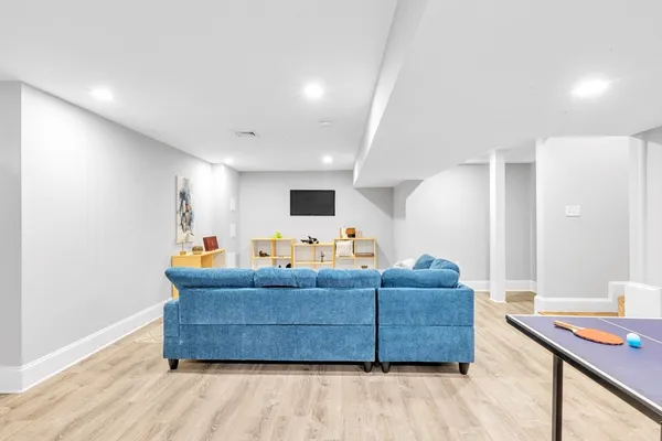 a living room with furniture and wooden floor